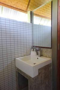 - Baño alicatado con lavabo blanco en Koh Mak Living, en Ko Mak