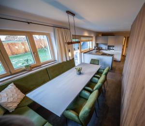a living room with a large white table and couch at Studio Weitblick in Saalbach-Hinterglemm