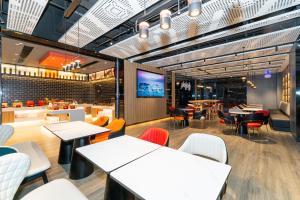 a restaurant with tables and chairs and a bar at Ibis Styles Hotel - 260M from Guangji Street Subway Station in Xi'an