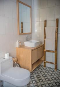 a bathroom with a white toilet and a sink at The Ganesha Homestay in Canggu +88 photos