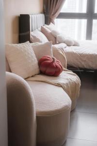 a row of pillows sitting on top of a couch at Ampang Neu Suites by DreamOak in Kuala Lumpur