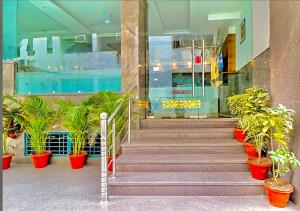 a staircase in a building with potted plants at Hotel Glace Airport Stay Near IGI Airport in New Delhi