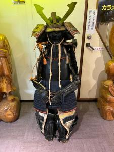 a statue of a person wearing a samurai suit at Takasago Onsen in Asahikawa
