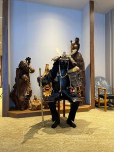 a statue of a man dressed in armour in a room at Takasago Onsen in Asahikawa