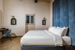 Letto o letti in una camera di Palazzo Castagna Boutique Hotel