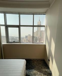 a room with a window with a view of the city at Nawazi Towers Hotel in Mecca