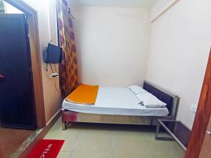 a small bedroom with a small bed in a room at Jayalaxmi Comforts in Hubli