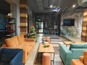 a living room with a christmas tree and couches at Borovets Dream Studio in Borovets