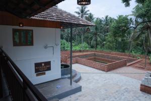 a view of a patio with a building with a fountain at Best Heritage Home in Iritti