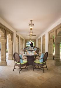 a dining room with a table and chairs at Taj Usha Kiran Palace, Gwalior in Gwalior