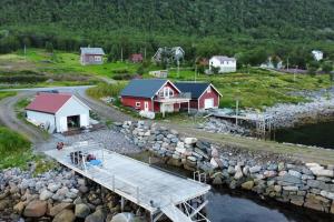 an aerial view of a village with a dock and houses at Leilighet i rorbu på Kaldfarnes - Yttersia Senja in Kaldfarnes