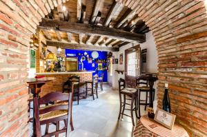 a bar with chairs and a brick wall at YIT Abentofail in Guadix