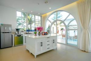 a kitchen with an island in the middle of a room at Mia Luxury Villa Bình Châu in Xuyên Mộc