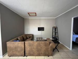 a living room with a couch and a tv at 1 on Titania in Polokwane