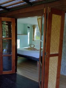 a view of a bedroom with a bed through an open door at Koh Mak Living in Ko Mak
