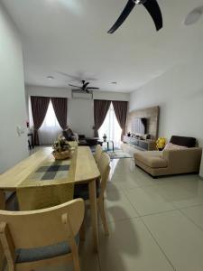 a living room with a dining table and a couch at Al Mansor Islamic Guestroom in Seremban