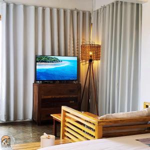 a living room with a television and a couch at Luna Tres Homestay Siargao in General Luna