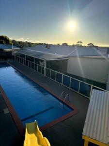 an overhead view of a swimming pool in a building at Relax, Resort Style in Rosebud