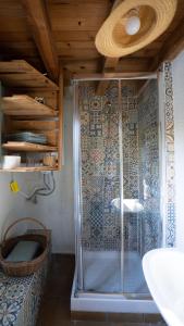 a shower with a glass door in a bathroom at El Zarzal in Horche