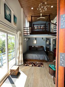 a bedroom with a large bed and a staircase at Sharma Nivas Holiday Homestay in Yelagiri