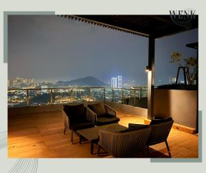 a balcony with couches and a view of a city at Neu Suites 006 A in Kuala Lumpur