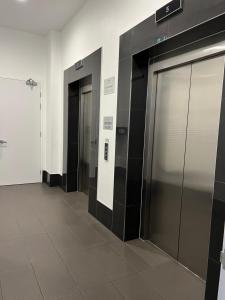 a row of elevator doors in a building at Fortitude Valley sharing apartments with other guests in Brisbane