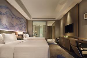 Uma cama ou camas num quarto em Wanda Realm Huangshi