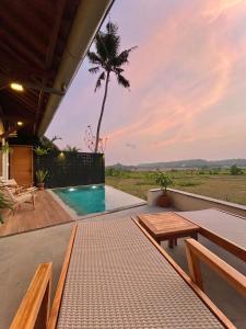 a villa with a swimming pool and a table at boutique villa jogja senang in Yogyakarta