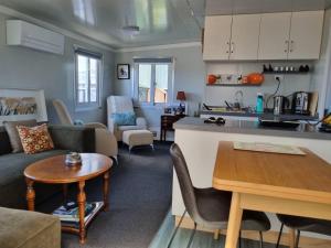 a kitchen and living room with a couch and a table at Queen Street Holiday Park in Richmond