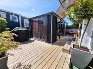 a deck of a house with a black container at Queen Street Holiday Park in Richmond