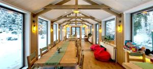a room with a long table and some windows at Vidra Park in Sicasău