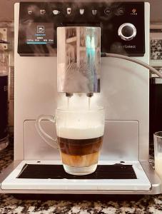 a cup of coffee in a espresso machine at Shiv Shakti Yogpeeth Cottages in Rishīkesh