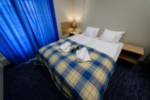 a hotel room with a bed with towels on it at HOSTEL PARKOWY in Morawica