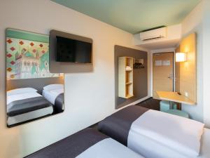 Postel nebo postele na pokoji v ubytování B&B Hotel Neuss