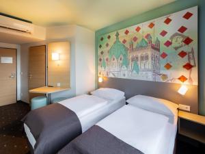 Postel nebo postele na pokoji v ubytování B&B Hotel Neuss
