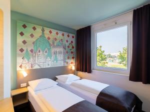 Postel nebo postele na pokoji v ubytování B&B Hotel Neuss