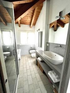 a bathroom with two toilets and a sink and a shower at Country house 15km from Bologna in Budrio +21 photos
