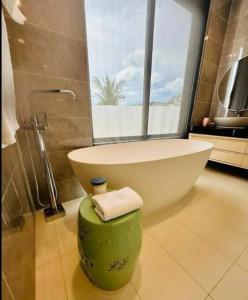 a bathroom with a bath tub and a bath tub at Villa WANNY in Amphoe Koksamui