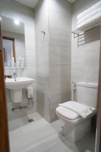 a bathroom with a toilet and a sink at Mangrove Place and Residences by Hiverooms in Mactan