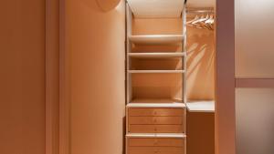 a closet with white shelves and drawers at Italianway - Garibaldi 93 B in Milan
