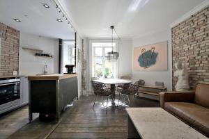 a living room with a couch and a table at Unique apartment in great location in Copenhagen