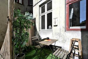a small patio with a table and a window at Unique apartment in great location in Copenhagen