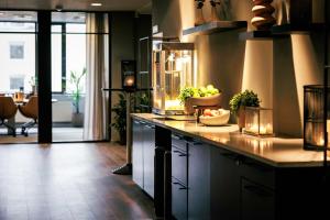 a kitchen with a counter with bowls of fruit on it at Quality Hotel Strand Gjøvik in Gjøvik