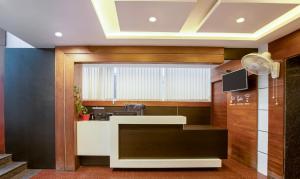 a lobby with a reception desk in a building at Treebo New Plus Point in Bengaluru