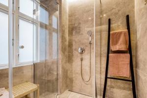 a bathroom with a shower with a glass door at Cherryy in Copenhagen +34 photos