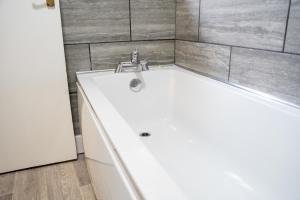 a bathroom with a sink and a bath tub at Chatham house in Etruria