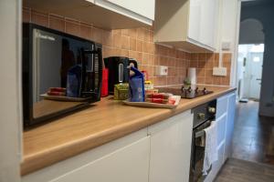 a kitchen with a counter top with some items on it at Chatham house in Etruria