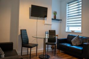 a living room with a table and a couch at Chatham house in Etruria