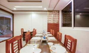 a long dining room with a long table and chairs at Treebo Trend New Plus Point in Bangalore