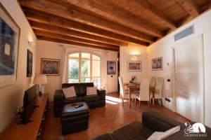 een woonkamer met een bank en een tafel bij Borgo del Torchio - App. 5H in Manerba del Garda